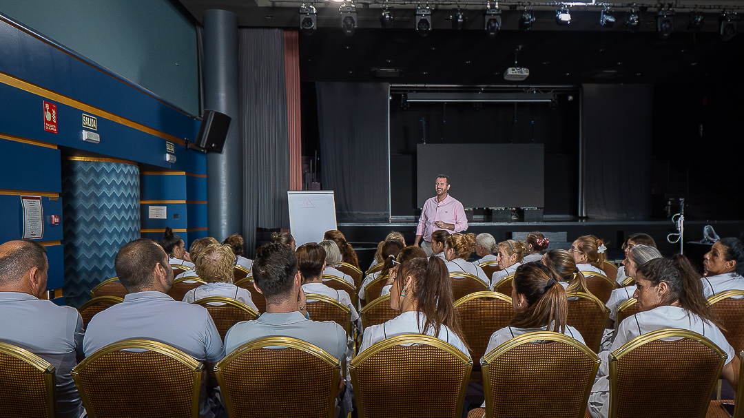 Corporate training auditorium session with hospitality team