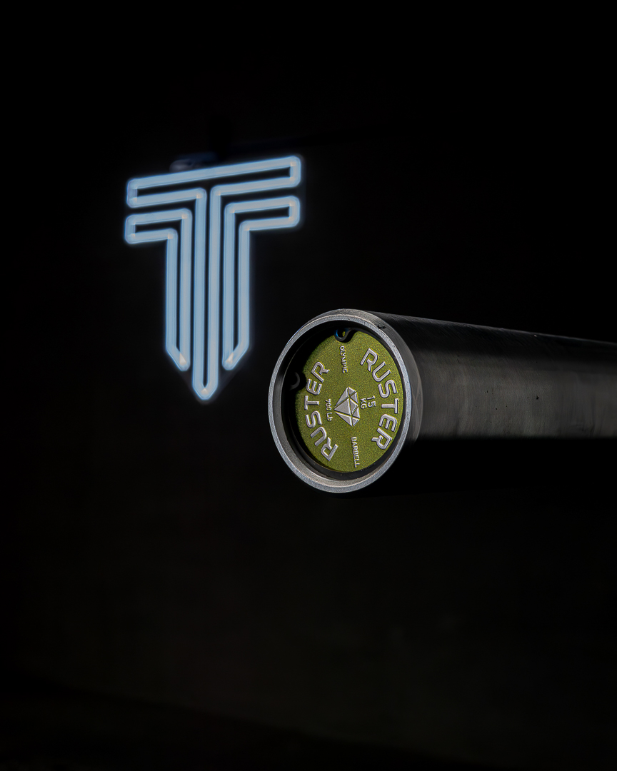 Premium gym branding shot with Olympic barbell and neon logo