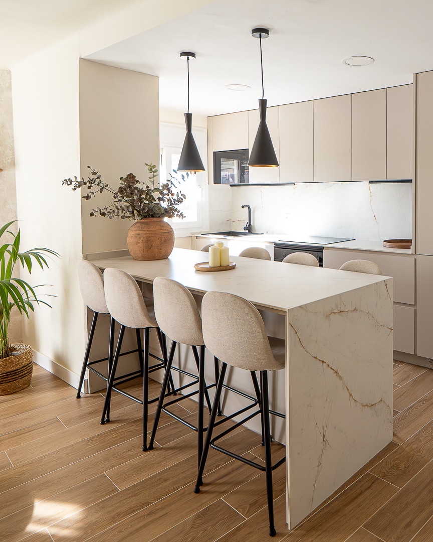 Designer kitchen with marble island and sculptural pendant lighting